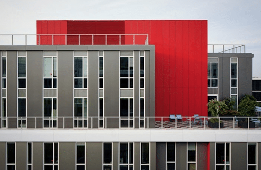 Contemporary commercial real estate building with grey and red walls
